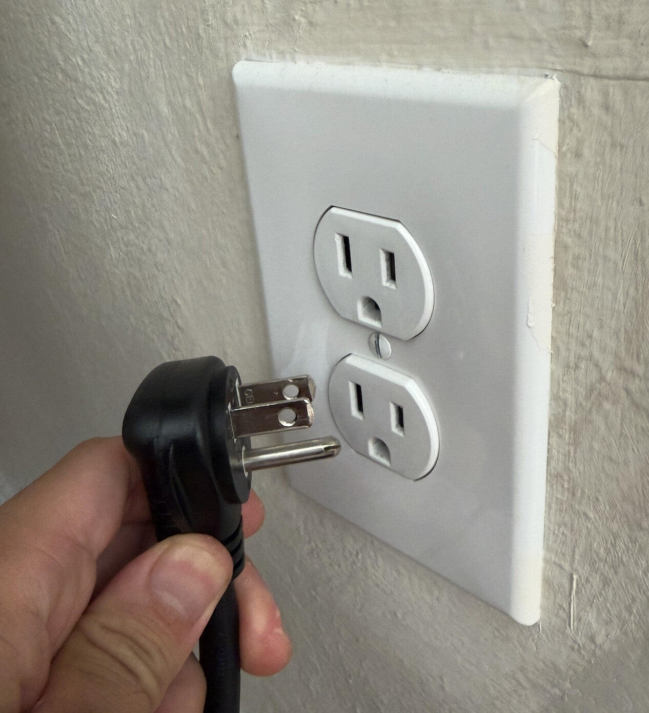Unplugging a Pila Mesh Home Battery's AC power cord from a wall receptacle