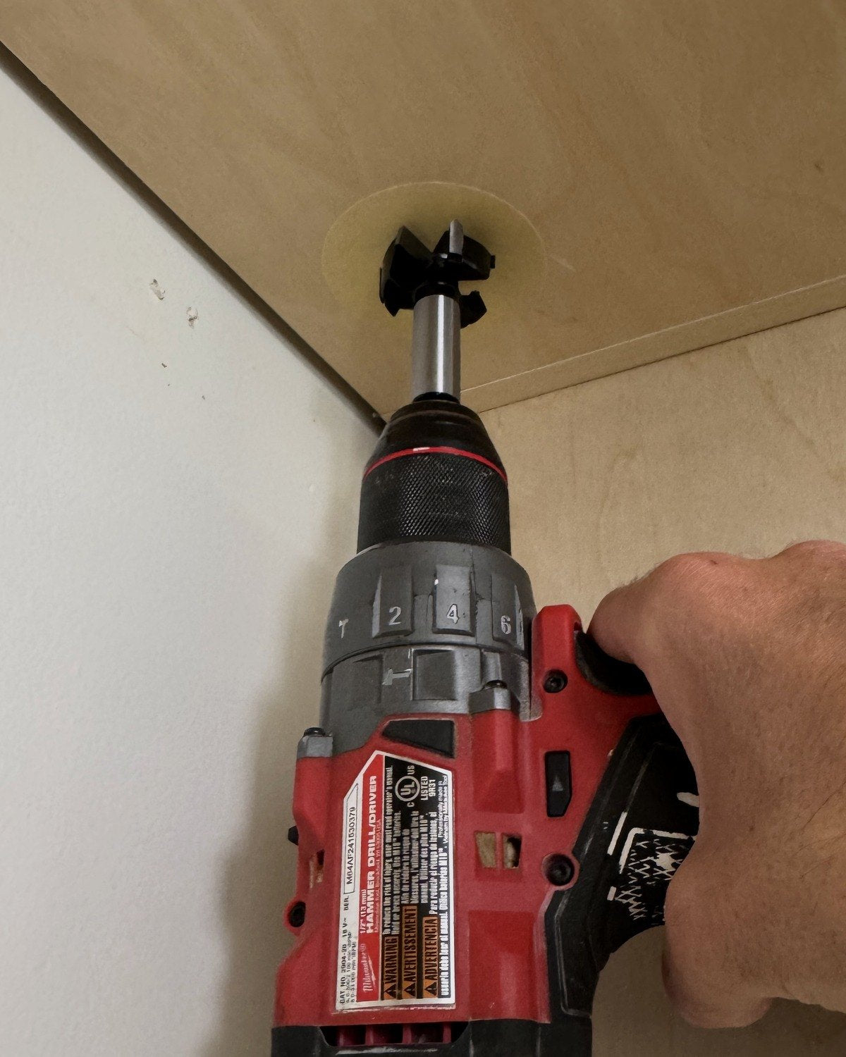 Widening the pilot hole with the 1.5 inch bit