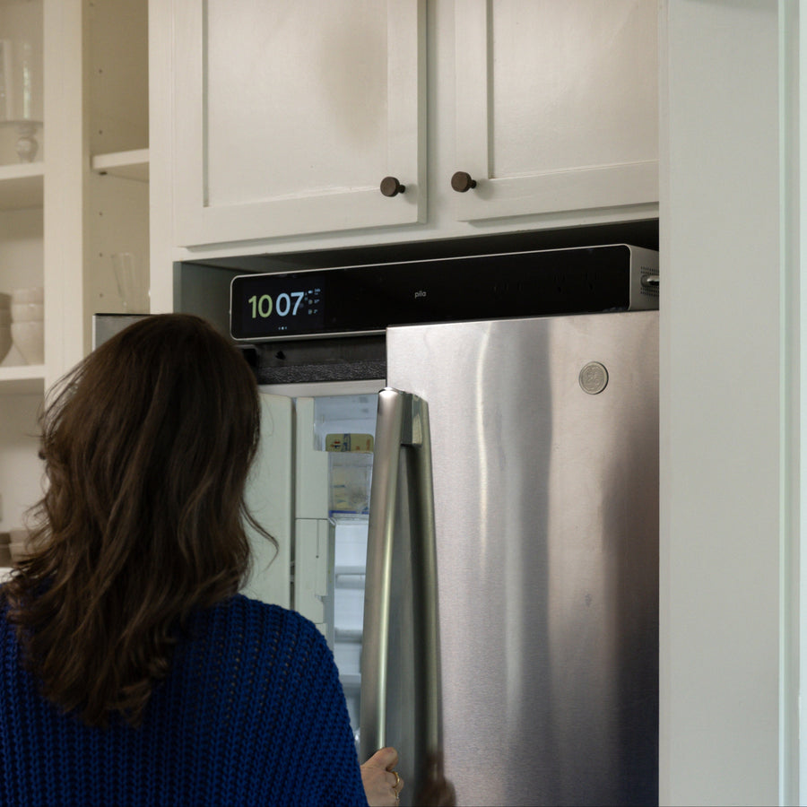 A Pila installed in the space above a refrigerator, with no visible cords